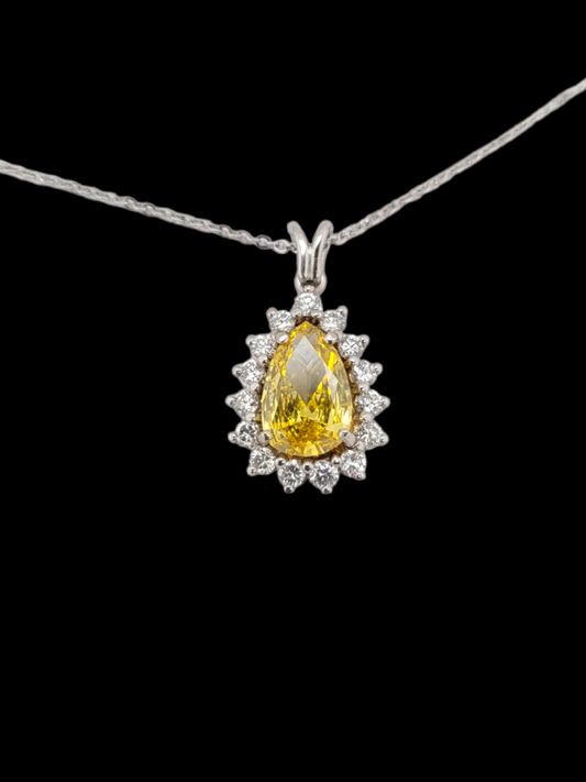 Yellow pear drop diamond with brilliant cut diamond surround