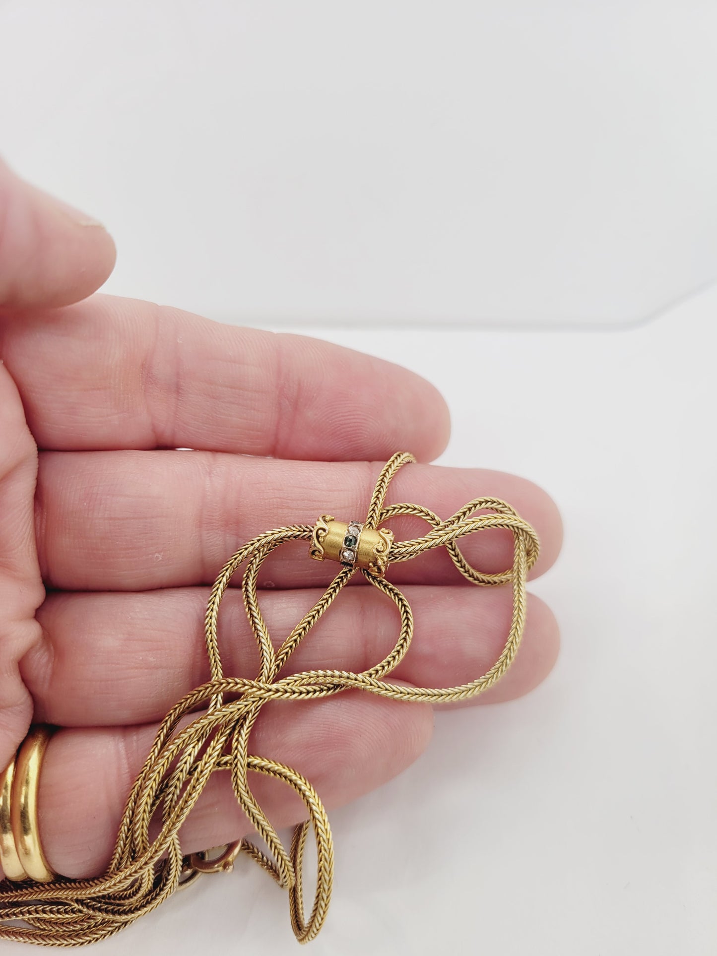 Antique long woven 18ct yellow gold chain with diamond and emerald slider
SKU: 8476